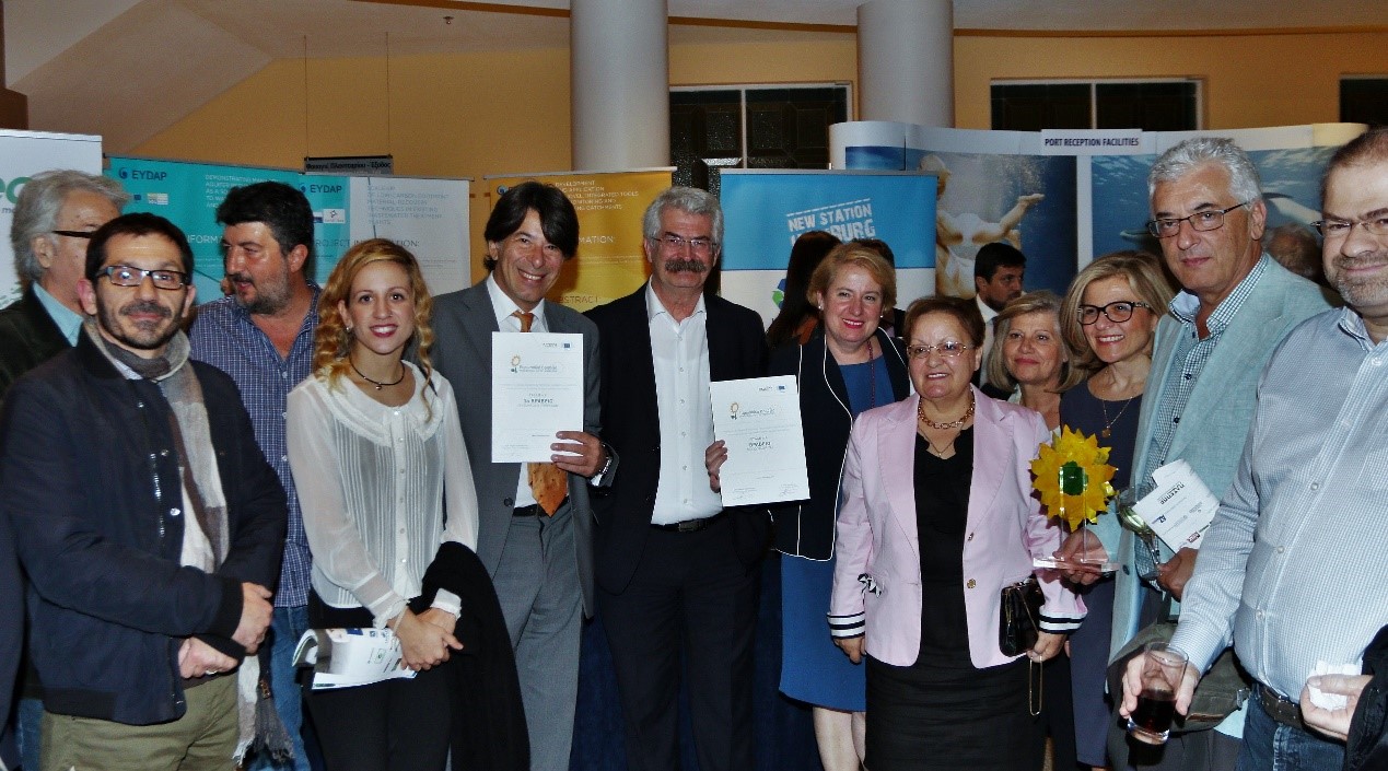 the-eydap-team-together-with-ntua-displaying-the-two-prizes-in-front-of-the-companys-stand-after-the-paseppe-awards